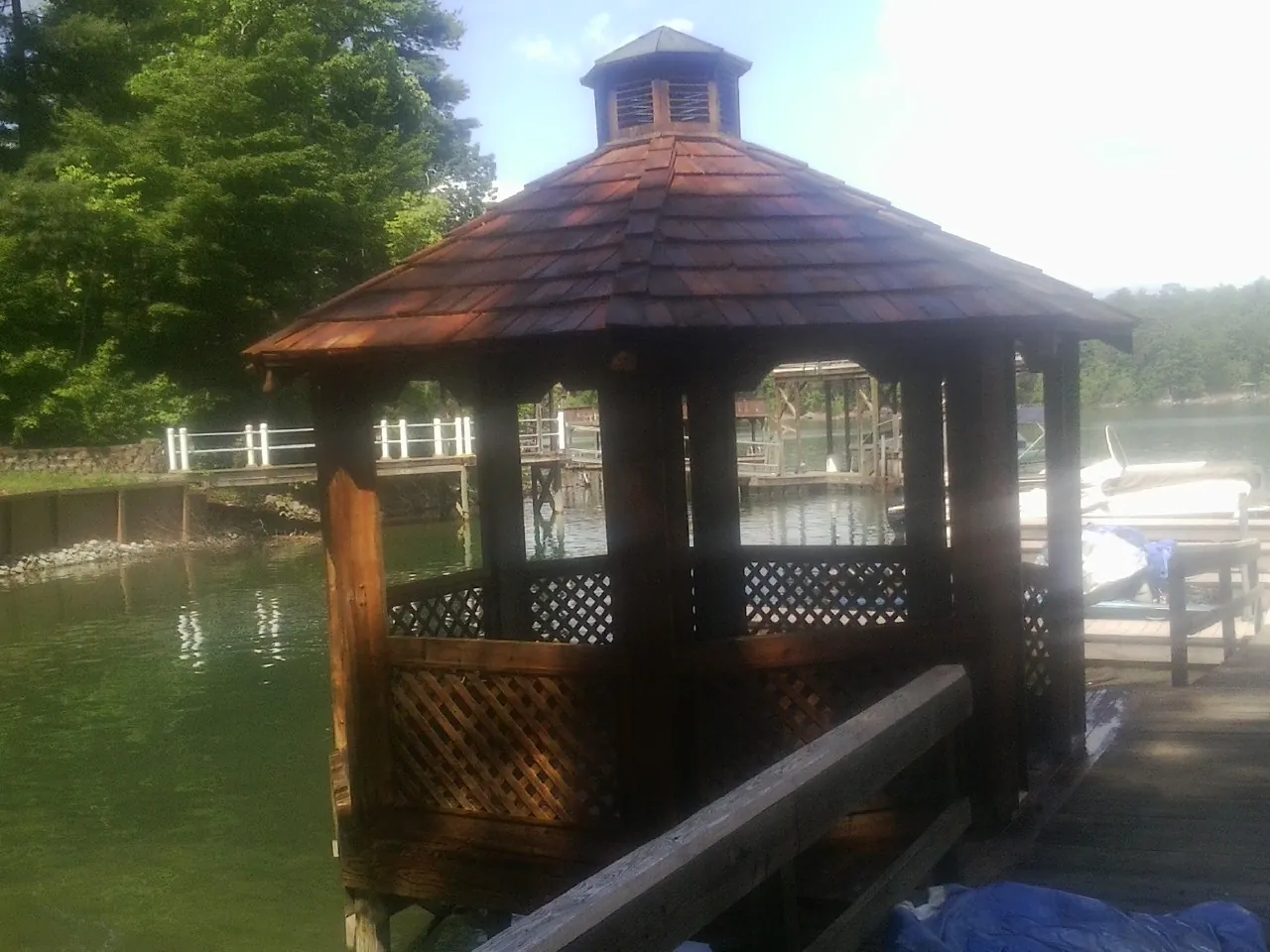 Cedar shake gazebo roof rebuilt on a lake dock in Willow Creek